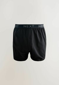 Čierne bavlnené boxerky s gombíkmi vpredu a elastickým pásom, na ktorom je opakovane šedé logo "NEXT". Hladká textúra.