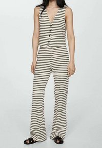 Striped knit jumpsuit featuring a deep V-neck, five buttons, and flared pants, in a cream and black color scheme with a textured design.