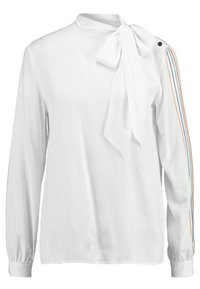 Valkoinen pitkähihais blouse, jossa on solmittava kaulus, ja jossa on värikäs raidallisuus yhdellä hihalla sekä nappi yksityiskohtana olkapäällä.