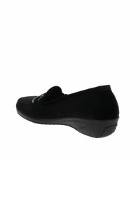 Scarpa slip-on in suede nero con punta arrotondata e cuciture sottili. Presenta una suola in gomma testurizzata per aderenza e durata.