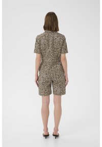 Short-sleeve, leopard print romper in tan and brown tones, features a fitted waist and shorts, made from lightweight fabric.