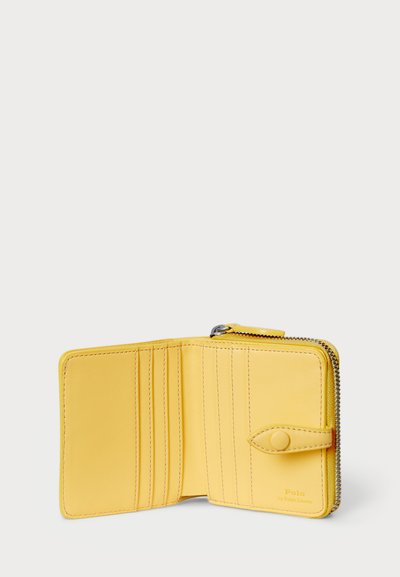 Yellow leather wallet with a zippered closure, multiple card slots, and a snap button accent. Smooth texture and minimalist design elements.