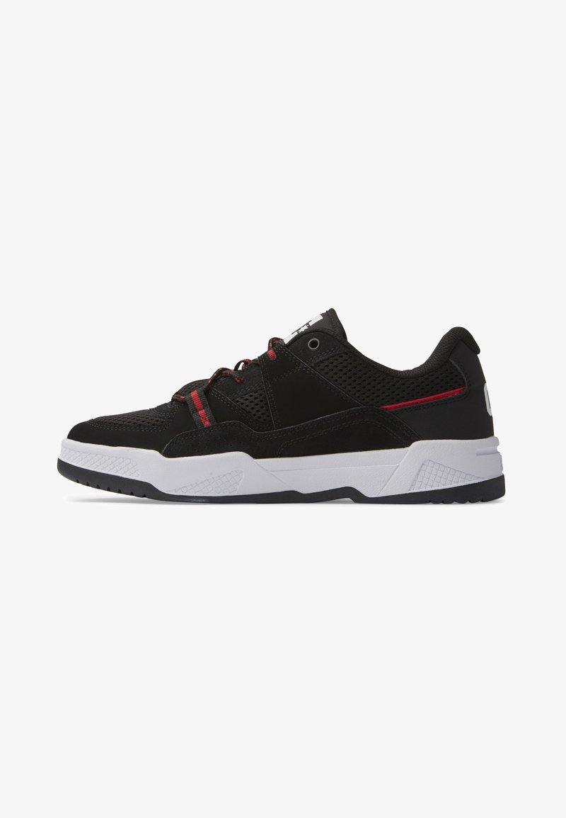 Black athletic sneakers featuring mesh and suede materials, with red accents, white midsole, and textured rubber outsole for traction.