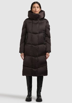 Long, puffy black coat with a high collar, zippered pockets, and a geometric quilted design. Made from a smooth, shiny fabric.