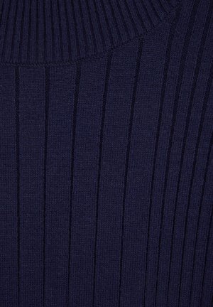 Navy blue ribbed sweater with a high neck, featuring vertical stripes and a soft, textured fabric. Ideal for layering in cooler weather.