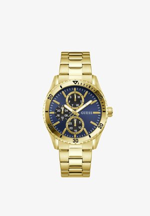 Reloj de pulsera de metal dorado con esfera azul, tres subesferas negras para día, fecha y hora en formato de 24 horas, y marcadores y manecillas doradas.