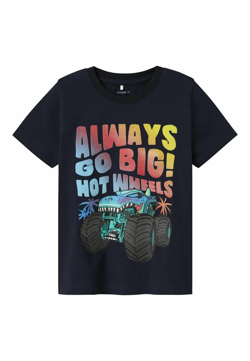 Camiseta de color azul marino con mangas cortas, que presenta una impresión gráfica de un camión monstruo, texto en negrita y acentos coloridos en rojo, azul y amarillo.