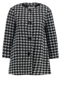Houndstooth-gepatteerde jas in zwart-wit, met een ronde hals, lange mouwen en zes zwarte knopen aan de voorkant.