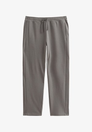 Pantaloni della tuta grigi realizzati in tessuto morbido, con vita elasticizzata e cordino, tasche laterali e gambe affusolate.