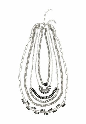 Sudraba tonis slāņotā kaklarota ar vairākiem ķēdes stiliem, satur melnas pērlītes un akcentus, ar dažādiem garumiem un gludu tekstūru.