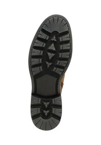 Suela de zapato de goma negra con un dibujo de patrones para tracción, que presenta crestas y una forma hexagonal distintiva en la sección central.