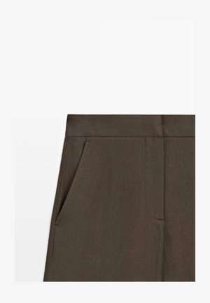 Dark brown pants waistband and upper section with angled front pocket and visible stitching details.