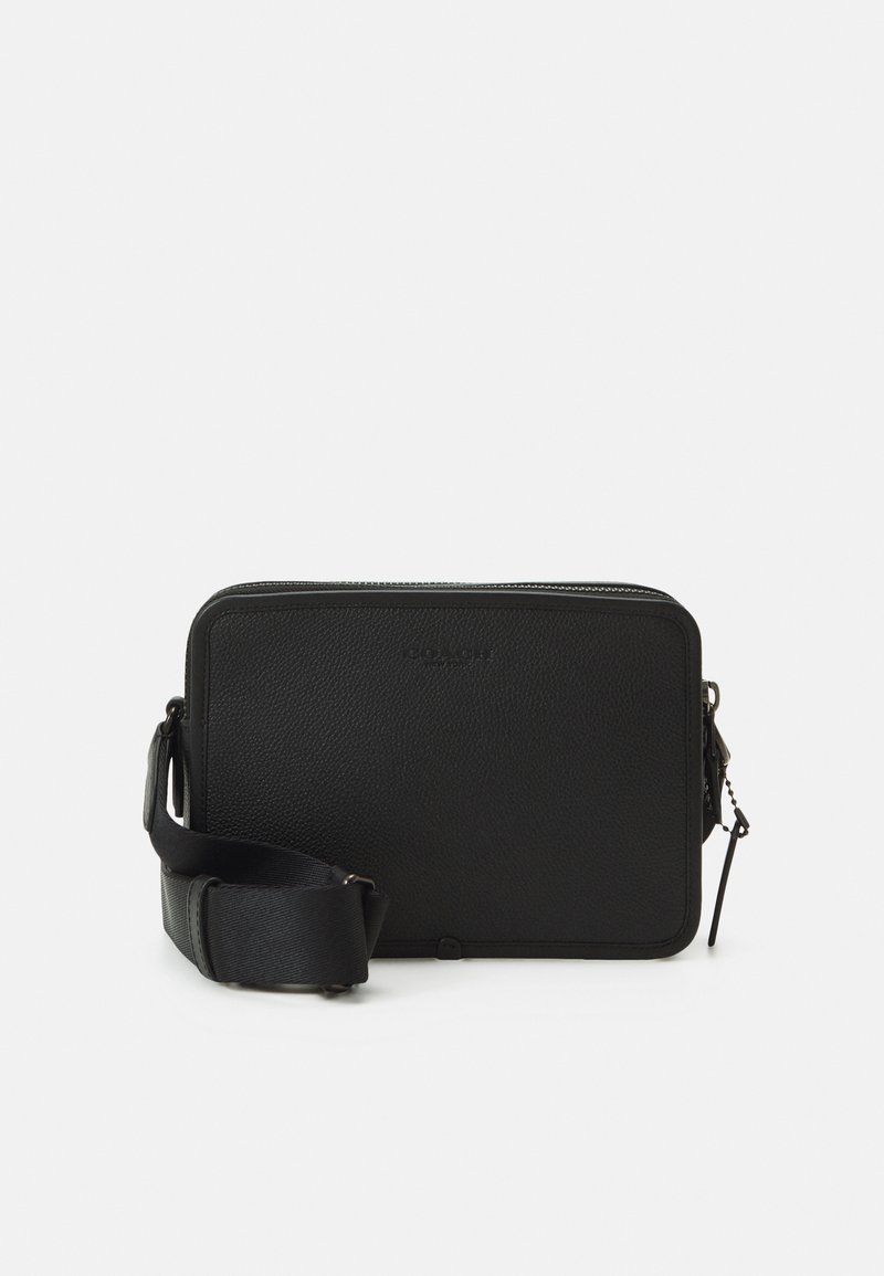 Black leather crossbody bag with a textured finish, rectangular shape, top zipper closure, and adjustable strap. Features subtle branding.