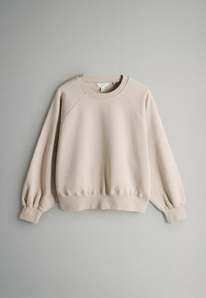 Beige Sweatshirt mit geripptem Rundhalsausschnitt, Raglanärmeln und elastischen Bündchen. Weicher Stoff mit leichtem Stretch, keine sichtbaren Muster oder Hardware.