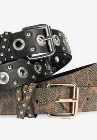 Two belts: one black leather with silver studs and eyelets, and one brown patterned leather with gold-colored hardware.