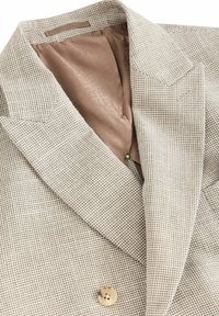Beige check-patterned blazer with a notched collar, brown satin lining, and a single button detail. Textured fabric.