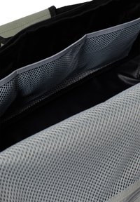 Gray fabric bag with a mesh pocket and smooth interior. Features black accents and a zipper closure. Interior textures vary between materials.