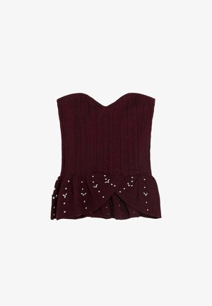 Top de punto sin tirantes en color burdeos con escote corazón y dobladillo acampanado decorado con pequeñas cuentas blancas.