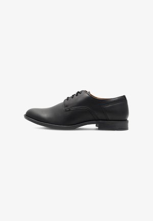 Schwarze Leder-Schuh mit glattem Finish, runder Zehenform, Schnürverschluss und niedrigem Blockabsatz. Mit subtilen Nähdetails.