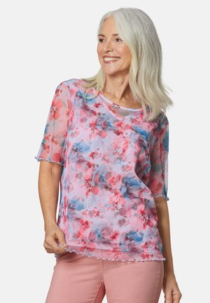 Durchsichtige Bluse mit kurzen Ärmeln im pastellfarbenen Blumenmuster, mit rosa, roten und blauen Farbtönen, gewellten Säumen und lockerer Passform.