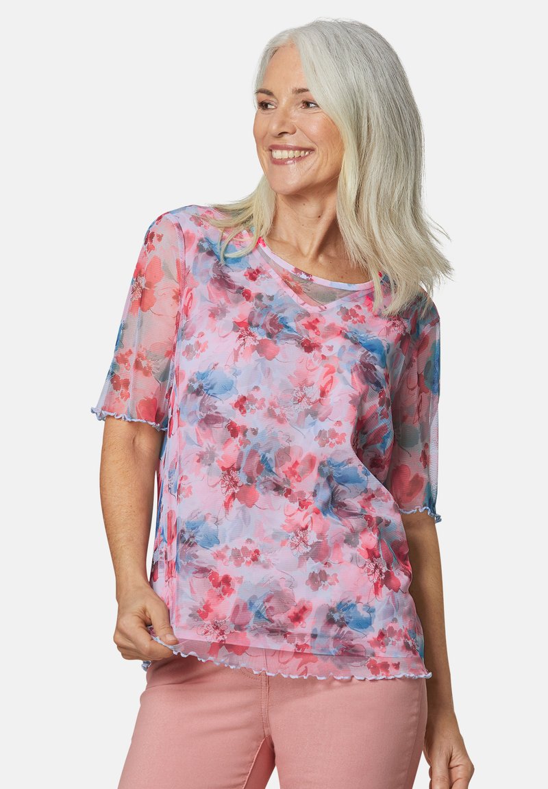Transparante blouse met korte mouwen in een pastelkleurig bloemenpatroon, met roze, rode en blauwe tinten, met geschulpte randen en een losse pasvorm.