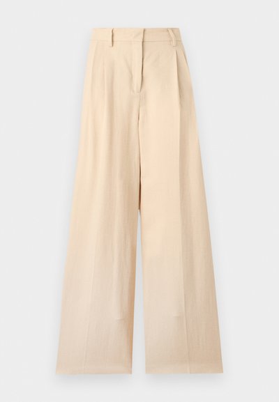 Pantalon beige taille haute à jambes larges avec passants de ceinture et fermeture éclair devant sur un fond uni clair.