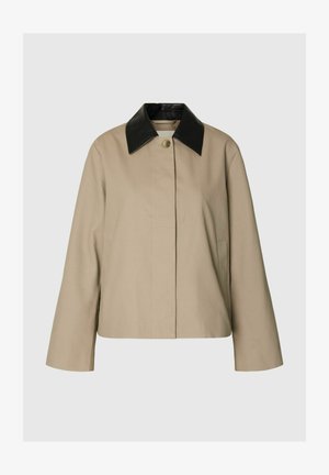 Beige jacket with long sleeves and a single button closure, featuring a contrasting black leather pointed collar.