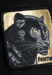 Black fabric patch featuring an embroidered panther's head with gold accents, detailed whiskers, and prominent green eyes. Text reads "PANTHER."