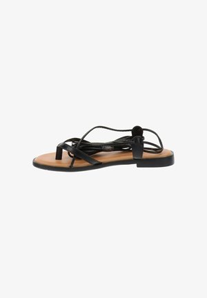 Sandalias planas negras con tiras entrelazadas, una plantilla contorneada de color bronceado y una suela de goma minimalista, que cuenta con un pequeño tacón cuadrado.