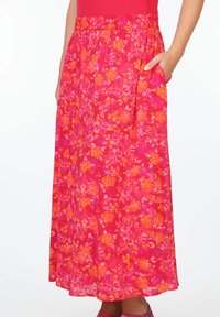 Blumen-Midi-Rock in leuchtendem Pink mit orangen und gelben Blumenmustern. Elastischer Bund mit Seitentasche, leichtes Material.