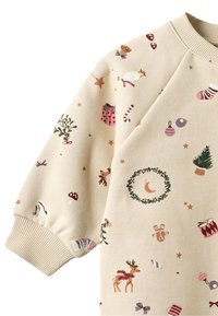Sweatshirt de couleur crème avec des motifs festifs comprenant des rennes, des cadeaux et des ornements. Poignets côtelés et tissu doux et texturé.
