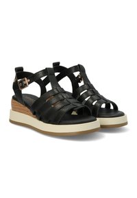 Infradito in pelle nera con cinghie incrociate, soletta imbottita e suola platform con accentuazione in legno e battistrada in gomma.