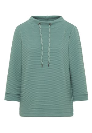 Texturovaný zelený top s vysokým límcem, má dlouhé rukávy a stahovací šňůrku na límci. Celoplošný vertikální ribovaný design.