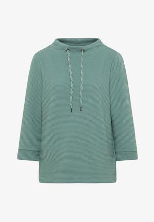 Haut vert texturé avec un col montant, doté de manches longues et d'une fermeture à cordon au niveau du col. Design à côtes verticales sur l'ensemble.