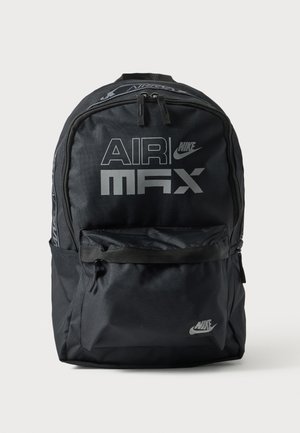 Musta Nike Air Max -reppu, jossa iso etutasku, kaksinkertaiset vetoketjut ja heijastavat logot edessä ja alaosassa.