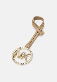 Brązowy skórzany brelok do kluczy z okrągłym, złotym metalowym zawieszką z logo "MK" oraz napisem "MICHAEL KORS" wzdłuż krawędzi.