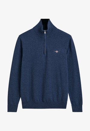 Mörkblå pullover-tröja med hög krage och halvvinddragare, tillverkad av strukturerad tyg; har en liten broderad logotyp på bröstet.