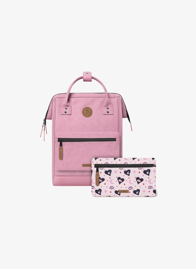 Pink faux leather backpack with top handle, front zip pocket; includes a patterned pink pouch with hearts, eyes, and crescent moons.