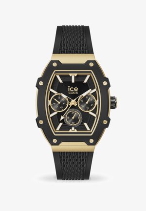 Gold- und schwarze Uhr mit einem achteckigen Gehäuse. Strukturiertes schwarzes Gummiarmband, drei Unterzifferblätter und klare Markierungen für Stunden und Tage.