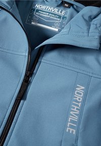 Niebieska wiatroszczelna i wodoodporna kurtka z zamkiem błyskawicznym oraz tekstem "NORTHVILLE" z boku; gładka tekstura i dopasowany krój.