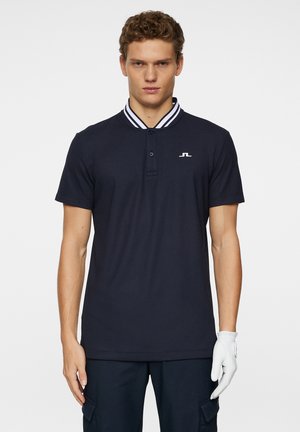 Navy polo shirt with white-striped collar, featuring a button placket and a small logo on the chest. Made from a textured fabric.