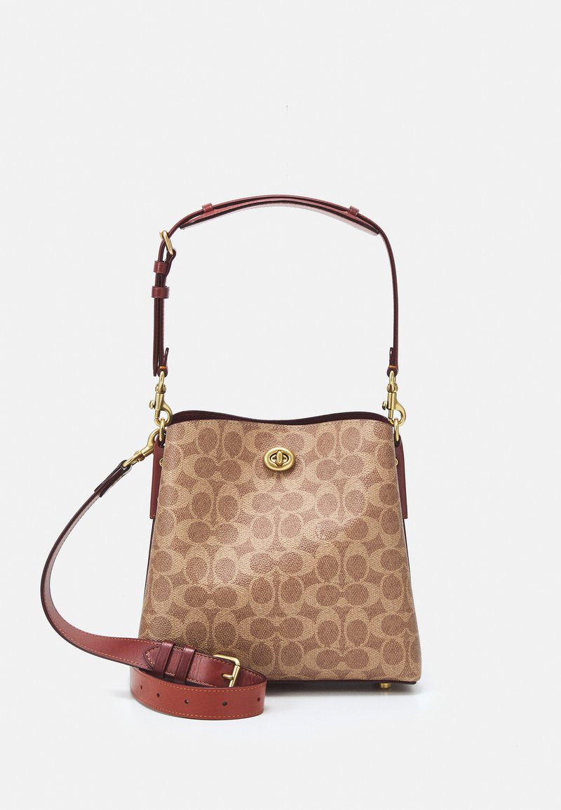 Brown patterned handbag with a gold logo, featuring leather accents and a removable shoulder strap. Includes a sturdy top handle.