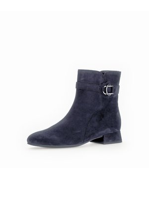 Navy blue suede ankle boot with a low block heel, featuring a strap and silver buckle accent. Smooth texture and streamlined design.