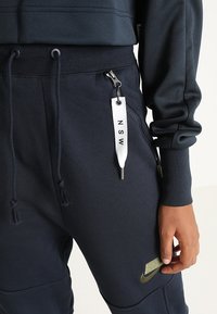 Nike Sportswear Teplákové kalhoty - dark blue