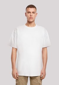 White oversized T-shirt with a crew neckline, short sleeves, and a smooth texture. Simple design, no visible patterns or accents.