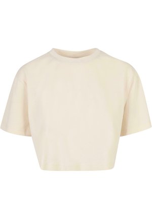 Cropped t-shirt made of soft fabric, featuring short sleeves, a round neckline, and a light beige color with a smooth texture.