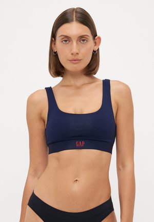 Marineblauwe sport-bh van een zachte katoenmix, met een vierkante halslijn en brede schouderbanden, met het "GAP"-logo in het rood op de band.