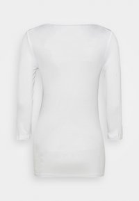 Top blanco de manga larga hecho de una tela ligera. Presenta un escote redondo y un diseño ajustado. Textura suave con un ligero brillo.