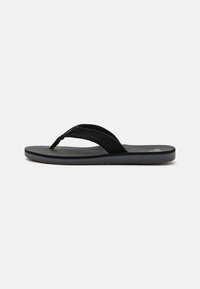 Tongs noires avec une semelle en caoutchouc texturé, équipées de deux sangles en tissu et d'un matelas de pied légèrement rembourré. Design simple, sans motifs visibles.