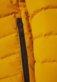 Bright yellow puffy jacket fabric with a textured surface features a black zip closure along the right side. Zipper has a tab for easy grip.